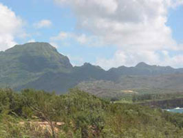 A view from the bluffs overlooking Poipu Beach, viewing inward toward the center of Kauai. A view from the bluffs